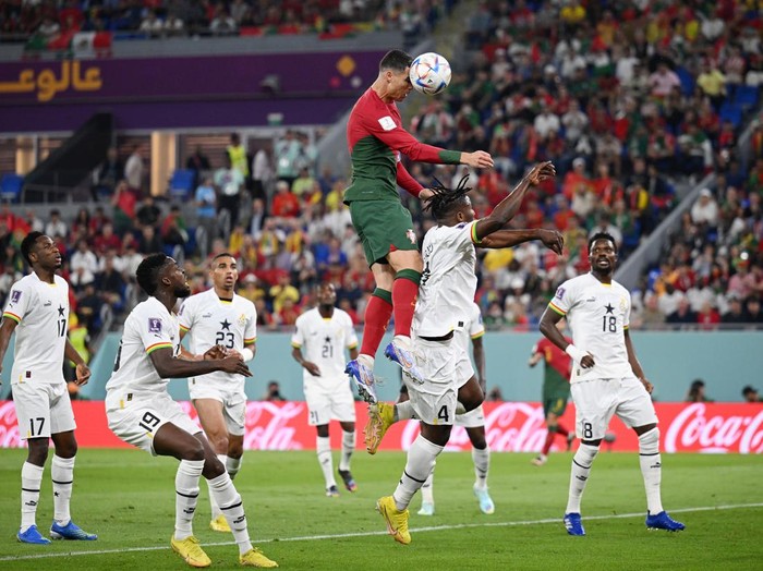DOHA, QATAR - NOVEMBER 24: Cristiano Ronaldo of Portugal competes for a header against Mohammed Salisu of Ghana during the FIFA World Cup Qatar 2022 Group H match between Portugal and Ghana at Stadium 974 on November 24, 2022 in Doha, Qatar. (Photo by Matthias Hangst/Getty Images)