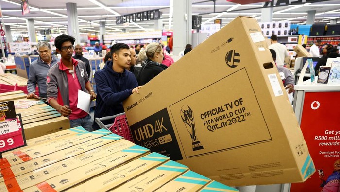 Shoppers are seen with new televisions in their cart during Black Friday shopping, at a store in Canal Walk Mall in Cape Town, South Africa, November 25, 2022. REUTERS/Esa Alexander