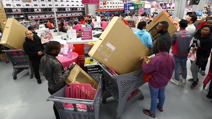 Shoppers are seen with new televisions in their cart during Black Friday shopping, at a store in Canal Walk Mall in Cape Town, South Africa, November 25, 2022. REUTERS/Esa Alexander