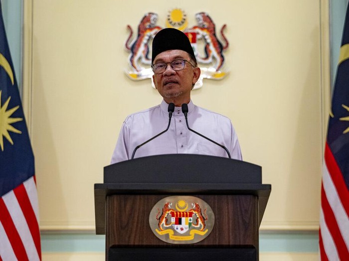 In this photo provided by Prime Minister Office, Malaysias Prime Minister Anwar Ibrahim speaks at a press conference on his first day at the prime ministers office in Putrajaya, Malaysia, Friday, Nov. 25, 2022. (Prime Minister office via AP)