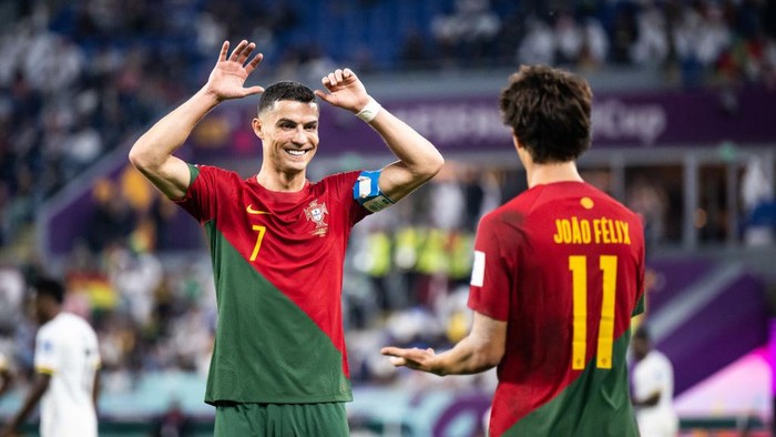 DOHA, QATAR - NOVEMBER 24: Joao Felix (R) of Portugal celebrates with Cristiano Ronaldo (L) after scoring his teams second goal  during the FIFA World Cup Qatar 2022 Group H match between Portugal and Ghana at Stadium 974 on November 24, 2022 in Doha, Qatar. (Photo by Marvin Ibo Guengoer - GES Sportfoto/Getty Images)