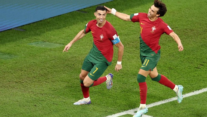 Soccer Football - FIFA World Cup Qatar 2022 - Group H - Portugal v Ghana - Stadium 974, Doha, Qatar - November 24, 2022 Portugals Cristiano Ronaldo celebrates scoring their first goal with Joao Felix REUTERS/Marko Djurica