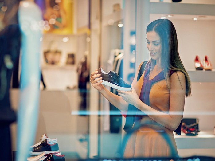 Young beautiful girl is looking shoes in the Mall