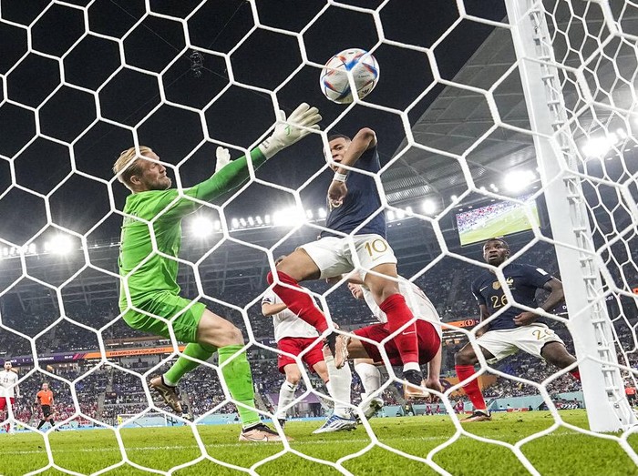 Frances Kylian Mbappe scores his sides second goal during the World Cup group D soccer match between France and Denmark, at the Stadium 974 in Doha, Qatar, Saturday, Nov. 26, 2022. (AP Photo/Martin Meissner)