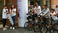 Head of Corporate Communication PT Adaro Energy Indonesia Tbk. Febriati Nadira bersama Marketing Departement Head-ITC Group Sinta K. Putri mengibarkan bendera start untuk melepas peserta Journalist MTB Fun Bike di ITC Permata Hijau, Jakarta.