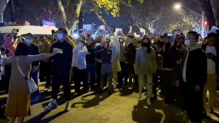 This frame grab from eyewitness video footage made available via AFPTV on November 27, 2022 shows demonstrators shouting slogans in Shanghai. - Angry crowds took to the streets in Shanghai in the early hours of November 27 and videos on social media showed protests in other cities across China, as public opposition to the government's hardline zero-Covid policy mounts. (Photo by AFPTV / AFP) (Photo by -/AFPTV/AFP via Getty Images)
