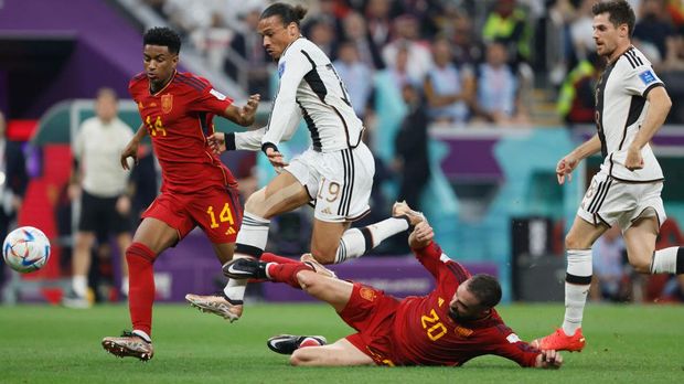 AL KHOR, QATAR - NOVEMBER 27: Alejandro Balde of Spain and Leroy Sane of Germany and Dani Carvajal of Spain challenge during the FIFA World Cup Qatar 2022 Group E match between Spain and Germany at Al Bayt Stadium on November 27, 2022 in Al Khor, Qatar. (Photo by Richard Sellers/Getty Images)