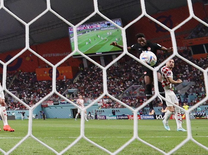 Canada's forward #19 Alphonso Davies scores the opening goal during the Qatar 2022 World Cup Group F football match between Croatia and Canada at the Khalifa International Stadium in Doha on November 27, 2022. (Photo by ADRIAN DENNIS / AFP) (Photo by ADRIAN DENNIS/AFP via Getty Images)