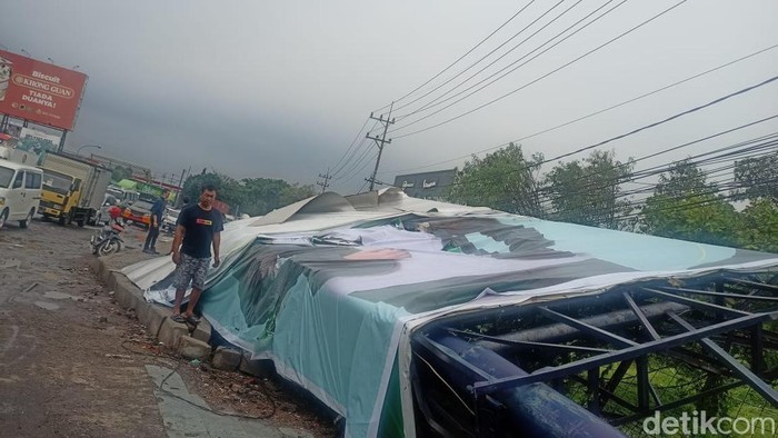 Hujan disertai angin kencang di kawasan Sidoarjo membuat baliho dan pohon tumbang