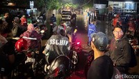 Terlihat sebuah mobil mogok di tengah-tengah banjir.