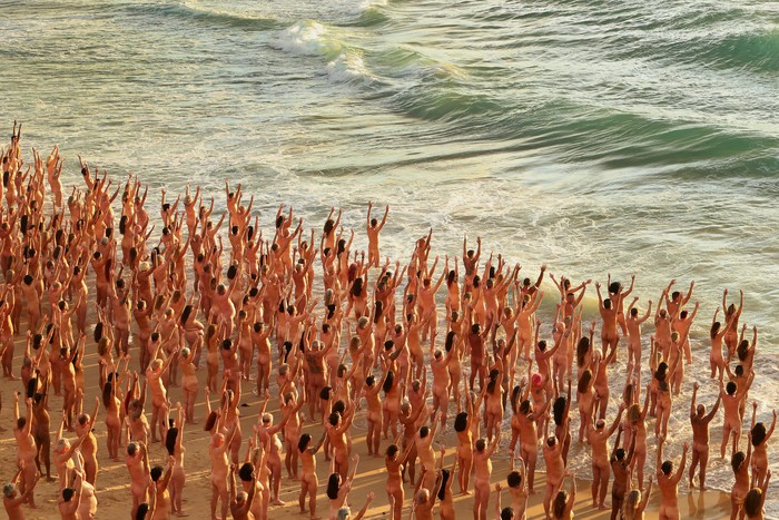 SYDNEY, AUSTRALIA - NOVEMBER 26: (EDITORS NOTE: Image contains nudity.) Members of the public pose at sunrise for photographic artist Spencer Tunick at Bondi Beach on November 26, 2022 in Sydney, Australia. US artist and photographer Spencer Tunick created the nude installation using thousands of volunteers posing at sunrise on Bondi Beach, commissioned by charity Skin Check Champions to raise awareness of skin cancer and to coincide with National Skin Cancer Action Week. (Photo by Lisa Maree Williams/Getty Images)