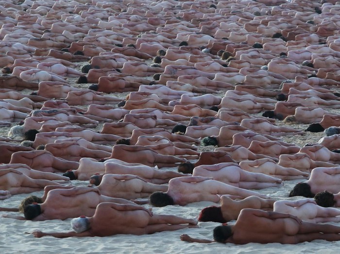 SYDNEY, AUSTRALIA - NOVEMBER 26: (EDITORS NOTE: Image contains nudity.) Members of the public pose at sunrise for photographic artist Spencer Tunick at Bondi Beach on November 26, 2022 in Sydney, Australia. US artist and photographer Spencer Tunick created the nude installation using thousands of volunteers posing at sunrise on Bondi Beach, commissioned by charity Skin Check Champions to raise awareness of skin cancer and to coincide with National Skin Cancer Action Week. (Photo by Lisa Maree Williams/Getty Images)
