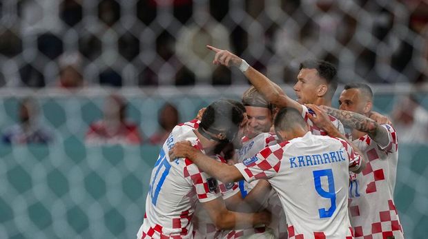 Croatia players celebrate after teammate Marko Livaja scored their side's second goal during the World Cup group F soccer match between Croatia and Canada, at the Khalifa International Stadium in Doha, Qatar, Sunday, Nov. 27, 2022. (AP Photo/Martin Meissner)