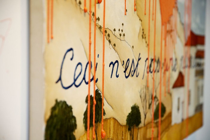 SYDNEY, AUSTRALIA - NOVEMBER 28: A general view of the artwork and artist is seen just after artist Caroline Zilinsky defaces her own painting , titled 'This is not a planet' ,  at a public viewing at Nanda Hobbs Gallery in Chippendale on November 28, 2022 in Sydney, Australia. Caroline Zilinsky defaced her own work to interrogate the reasoning behind climate group 
