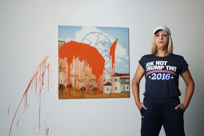 SYDNEY, AUSTRALIA - NOVEMBER 28: A general view of the artwork and artist is seen just after artist Caroline Zilinsky defaces her own painting , titled 'This is not a planet' ,  at a public viewing at Nanda Hobbs Gallery in Chippendale on November 28, 2022 in Sydney, Australia. Caroline Zilinsky defaced her own work to interrogate the reasoning behind climate group 