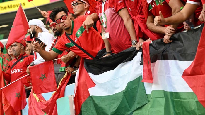 DOHA, QATAR - NOVEMBER 27: Fans of Morocco show their support to the Palestinian flag during the FIFA World Cup Qatar 2022 Group F match between Belgium and Morocco at Al Thumama Stadium on November 27, 2022 in Doha, Qatar. (Photo by Lionel Hahn/Getty Images)