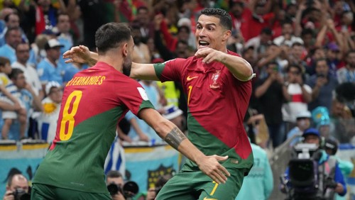LUSAIL CITY, QATAR - NOVEMBER 28: Cristiano Ronaldo of Portugal celebrates his sides first goal during the FIFA World Cup Qatar 2022 Group H match between Portugal and Uruguay at Lusail Stadium on November 28, 2022 in Lusail City, Qatar. (Photo by Etsuo Hara/Getty Images)