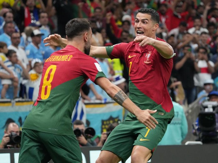 LUSAIL CITY, QATAR - NOVEMBER 28: Cristiano Ronaldo of Portugal celebrates his side's first goal during the FIFA World Cup Qatar 2022 Group H match between Portugal and Uruguay at Lusail Stadium on November 28, 2022 in Lusail City, Qatar. (Photo by Etsuo Hara/Getty Images)