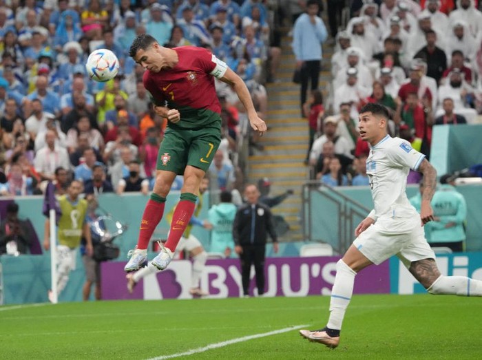 LUSAIL CITY, QATAR - NOVEMBER 28: Cristiano Ronaldo of Portugal attempts a shot during the FIFA World Cup Qatar 2022 Group H match between Portugal and Uruguay at Lusail Stadium on November 28, 2022 in Lusail City, Qatar. (Photo by Etsuo Hara/Getty Images)