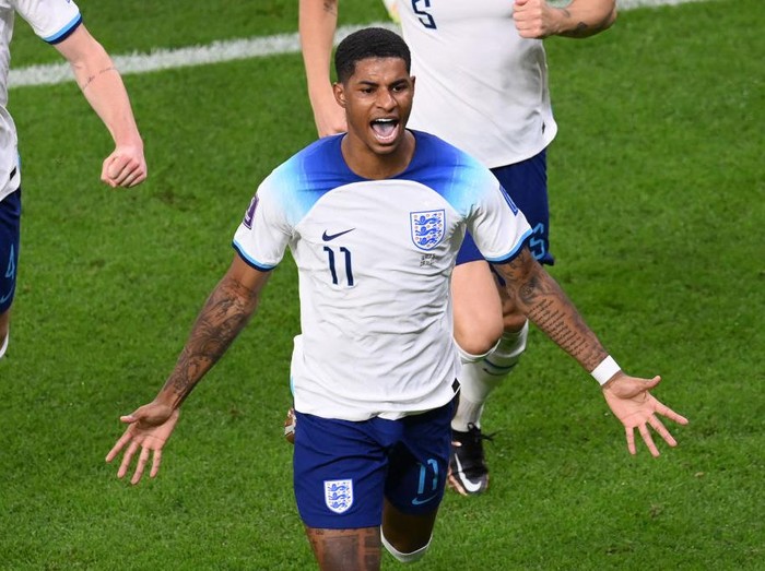 DOHA, QATAR - NOVEMBER 29: Marcus Rashford of England celebrates after scoring their team's first goal during the FIFA World Cup Qatar 2022 Group B match between Wales and England at Ahmad Bin Ali Stadium on November 29, 2022 in Doha, Qatar. (Photo by Stu Forster/Getty Images)