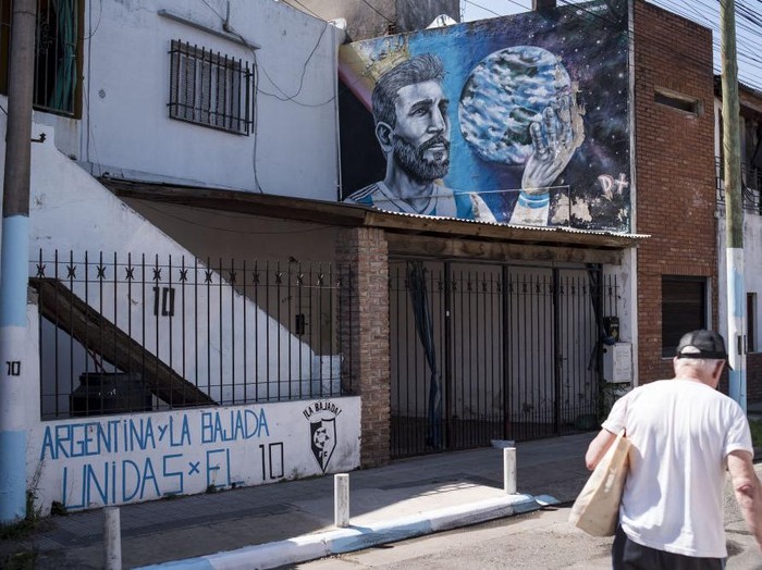Artists Marlene Zuriaga and Lisandro Urteaga finish the details of a mural depicting Argentine football star Lionel Messi in his childhood home in Rosario, Argentina, on November 26, 2022. (Photo by MARCELO MANERA / AFP) (Photo by MARCELO MANERA/AFP via Getty Images)