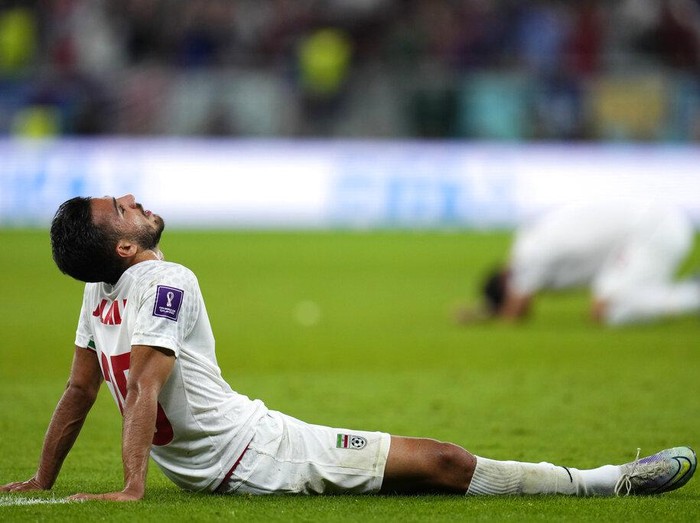 Iran's Abolfazl Jalali lies one the pitch after the World Cup group B soccer match between Iran and the United States at the Al Thumama Stadium in Doha, Qatar, Wednesday, Nov. 30, 2022. (AP Photo/Manu Fernandez)