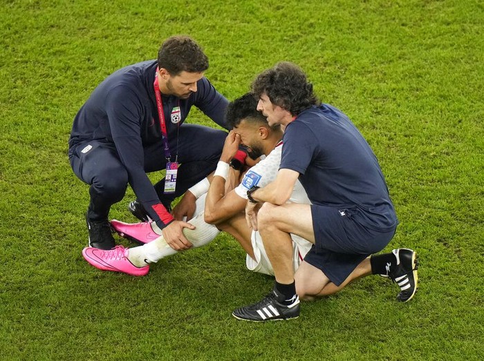 Iran's Ramin Rezaeian cries at the end of the World Cup group B soccer match between Iran and the United States at the Al Thumama Stadium in Doha, Qatar, Wednesday, Nov. 30, 2022. (AP Photo/Luca Bruno)