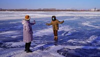Tak hanya menjadi incaran swafoto para warga. Biasanya, sungai Songhua yang membeku ini juga dijadikan tempat bermain ice skating.