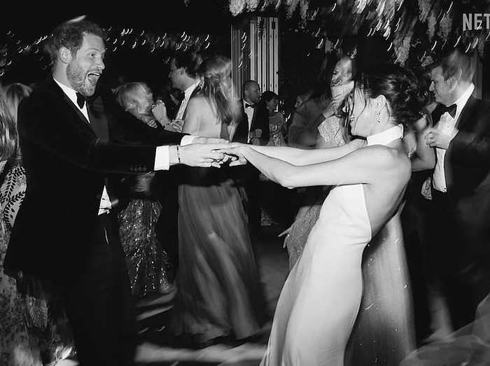 This image released by Netflix shows Prince Harry and Meghan, Duke and Duchess of Sussex, in a scene from the upcoming documentary Harry & Meghan, directed by Liz Garbus. (Netflix via AP)