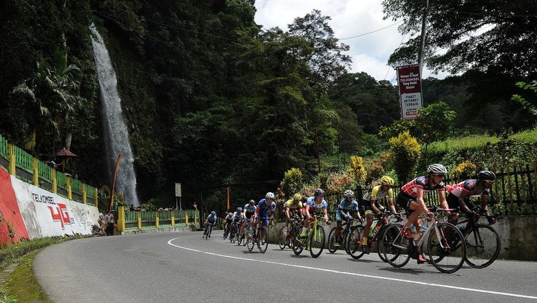PADANG, INDONESIA - NOVEMBER 18:  Cyclists compete pass trough Lembah Anai waterfall during stage 1 of the Tour de Singkarak 2017, Tanah Datar-Padang 109,3 km on November 18, 2017 in Padang, Indonesia.  (Photo by Robertus Pudyanto/Getty Images)