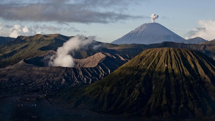 PROBOLINGGO, INDONESIA - JULY 23: General view of the Bromo Tengger Semeru National Park, showing Mount Bromo, Mount Semeru and Mount Batok, the location of the Tenggerese villages where the Tenggerese Hindu Yadnya Kasada Festival is held, in the background, on July 23, 2013 in Probolinggo, Indonesia. The festival is the main festival of the Tenggerese people and lasts about a month. On the fourteenth day, the Tenggerese make the journey to Mount Bromo to make offerings of rice, fruits, vegetables, flowers and livestock to the mountain gods by throwing them into the volcanos caldera. The origin of the festival lies in the 15th century when a princess named Roro Anteng started the principality of Tengger with her husband Joko Seger, and the childless couple asked the mountain Gods for help in bearing children. The legend says the Gods granted them 24 children but on the provision that the 25th must be tossed into the volcano in sacrifice. The 25th child, Kesuma, was finally sacrificed in this way after initial refusal, and the tradition of throwing sacrifices into the caldera to appease the mountain Gods continues today. (Photo by Ulet Ifansasti/Getty Images)