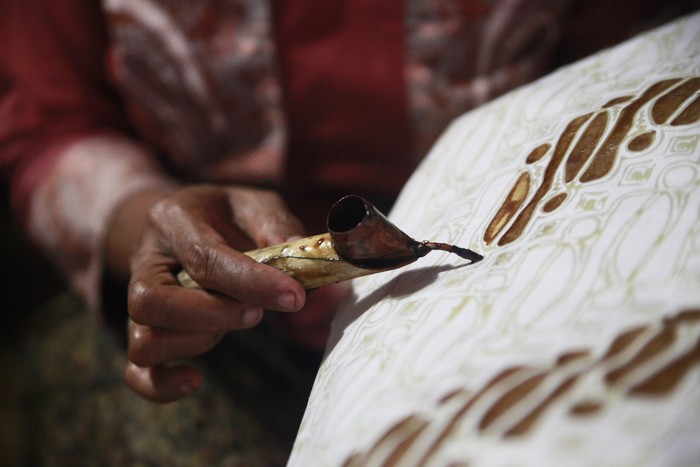 Batik or mbatik is a wax-resist dyeing technique to paint on a cloth. This technique came from Java, Indonesia. Canting, a spouted tool are usually used for drawing dots and lines on a cloth. Picture was taken in Kauman village, Solo, Central Java.