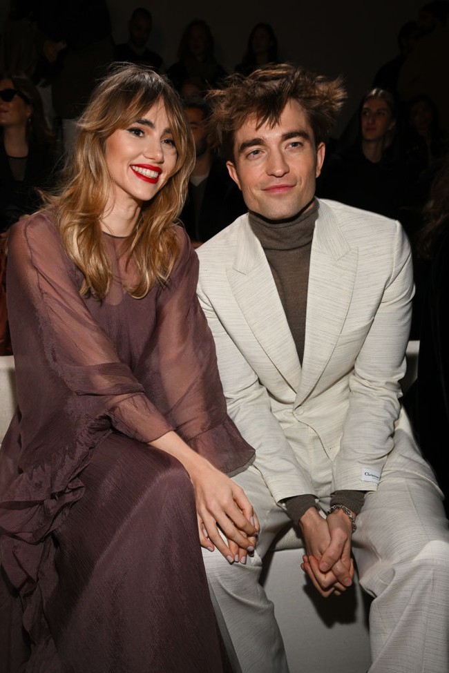 Robert Pattinson memilih gaya necis dengan setelan jas krem dan turtleneck cokelat. Foto: Getty Images