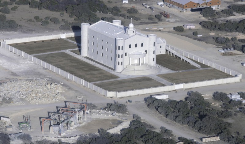 Adult members of The Fundamentalist Church of Jesus Christ of Latter-day Saints gather as children play with bottles of bubble water on the grounds of their temporary housing at Fort Concho National Historic Landmark in San Angelo, Texas, Apr. 7, 2008. (AP Photo/Tony Gutierrez)