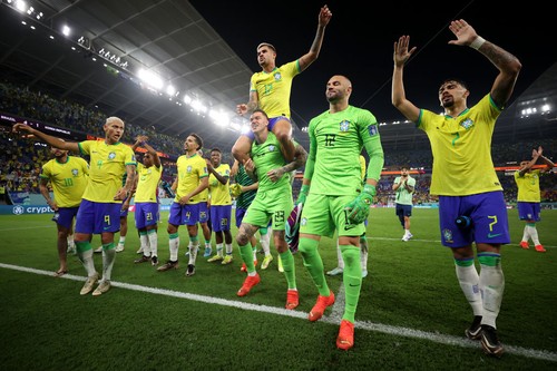 DOHA, QATAR - DECEMBER 05: Neymar of Brazil celebrates with Raphinha, Lucas Paqueta and Vinicius Junior after scoring the teams second goal via a penalty during the FIFA World Cup Qatar 2022 Round of 16 match between Brazil and South Korea at Stadium 974 on December 05, 2022 in Doha, Qatar. (Photo by Francois Nel/Getty Images)