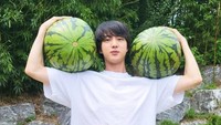 Pada musim panas, semangka menjadi buah yang diburu oleh Jin BTS. Demi menyegarkan tubuhnya, ia bahkan mengangkat dua buah semangka berukuran besar sekaligus. Foto: Instagram/jin
