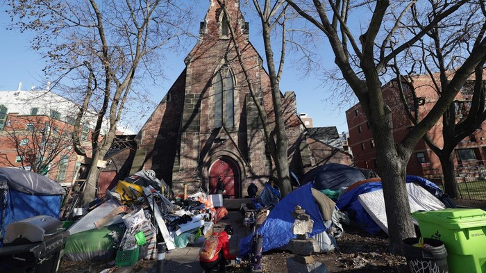 TORONTO, ON - DECEMBER 4 - Volunteers and residents help tidy an encampment outside The Church of Saint Stephen-in-the-Fields in Toronto, December 4, 2022. The Church of Saint Stephen-in-the-Fields is trying to clear out as much clutter as possible from its surrounding encampments, facing notice from the city that it'll clear out everything that isn't a tent from the perimeter on Monday, and a separate notice that the entire encampment on the west side needs to be gone by Thursday. (Steve Russell/Toronto Star via Getty Images)