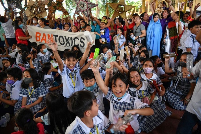 Teachers, students and parents hold Christmas lanterns made from recycled materials during a campaign for a toxic-free and waste-free Christmas celebration at an elementary school in Quezon City on December 7, 2022. (Photo by Ted ALJIBE / AFP) (Photo by TED ALJIBE/AFP via Getty Images)