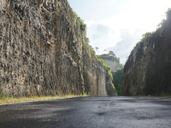 Jalan yang membelah bukit kapur menuju pantai seperti lukisan alam yang menarik untuk diabadikan dalam bingkai. Tak ayal lokasi ini jadi spot favorit untuk prewedding. Foto: Agus Eka/detikBali
