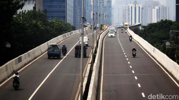 Para pemotor memacu kendaraan di jalan layang non tol Tanah Abang-Tebet, Jakarta, Rabu (7/12/2022). Jalan layang tersebut terlatang bagi kendaraan roda dua untuk melintas. Namun, para pemotor berani menerobos karena belum ada fasilitas tilang elektronik (ETLE) di ruas jalan tersebut. Satu pembonceng terlihat tidak mengenakan helm.