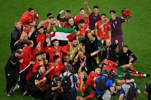 Para pemain Maroko merayakan akhir pertandingan sepak bola babak 16 besar Piala Dunia Qatar 2022 antara Maroko dan Spanyol di Education City Stadium di Al-Rayyan, sebelah barat Doha pada 6 Desember 2022. (Photo by Glyn KIRK / AFP)