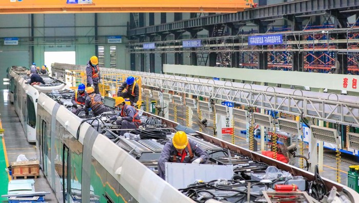 YIBIN, CHINA - DECEMBER 06: Workers assemble a smart rail tram at the assembly workshop in Sanjiang new district's Smart Rail Industrial Park on December 6, 2022 in Yibin, Sichuan Province of China. (Photo by VCG/VCG via Getty Images)