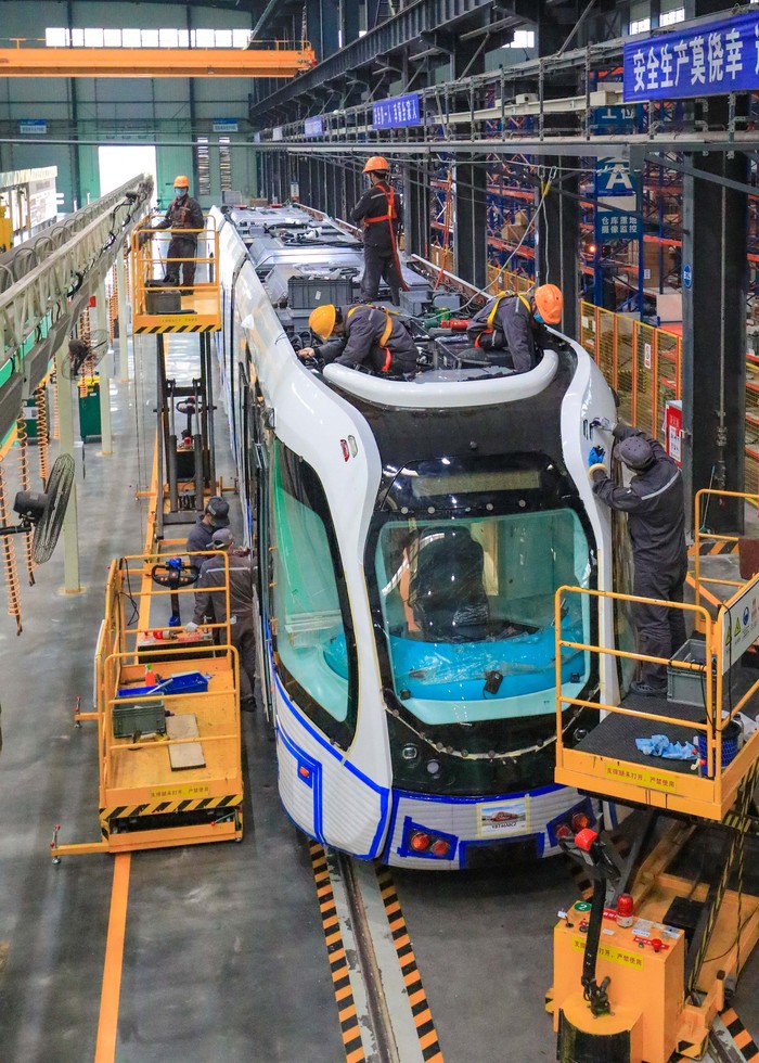 YIBIN, CHINA - DECEMBER 06: Workers assemble a smart rail tram at the assembly workshop in Sanjiang new district's Smart Rail Industrial Park on December 6, 2022 in Yibin, Sichuan Province of China. (Photo by VCG/VCG via Getty Images)