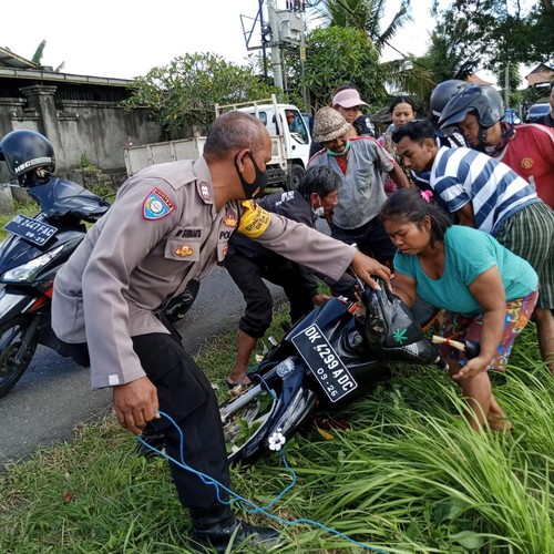 Polisi dan warga saat mengevakuasi motor terendam di parit Banjar Panglan, Kelurahan Kapal, Badung, Rabu (7/12/2022) siang.