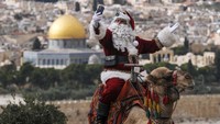 Issa Kassissieh yang mengenakan kostum sinterklas juga sempat swafoto dengan latar belakang Dome of the Rock.