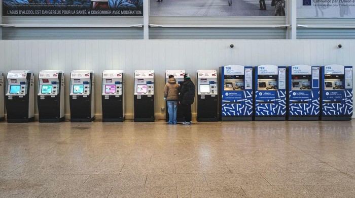 People purchase tickets at Lyon Part-Dieu railway station, on December 7, 2022 during a strike by railway workers to call for pay raises. (Photo by OLIVIER CHASSIGNOLE / AFP) (Photo by OLIVIER CHASSIGNOLE/AFP via Getty Images)