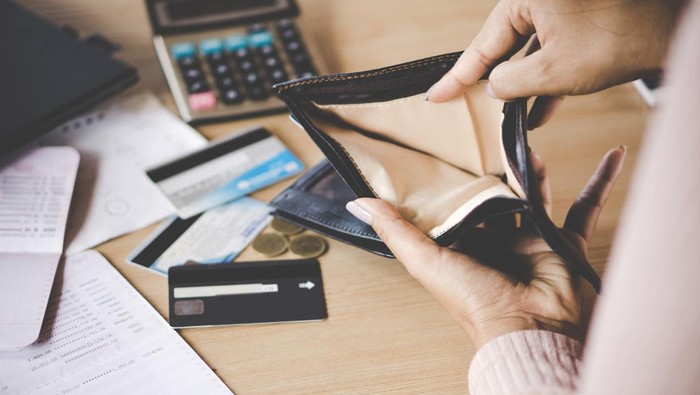 poor Asian woman hand open empty purse looking for money having problem  bankrupt broke after credit card payday