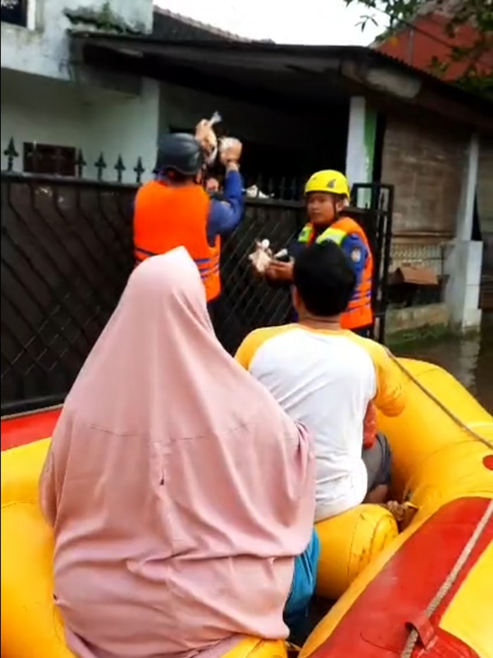 Perumahan di Depok terendam banjir akibat aliran sungai tertutup longsor. Petugas damkar membagikan makanan kepada warga dan PUPR mengangkut puing longsor. (IG @depokfirerescue113)