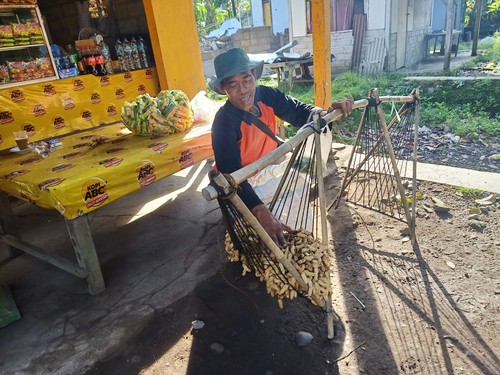Salah seorang pedagang kacang rebus keliling saat merapikan dagangannya di salah satu warung di Desa Yehembang, Kecamatan Mendoyo, Kabupaten Jembrana, Kamis (08/12/2022). Foto: I Putu Adi Budiastrawan