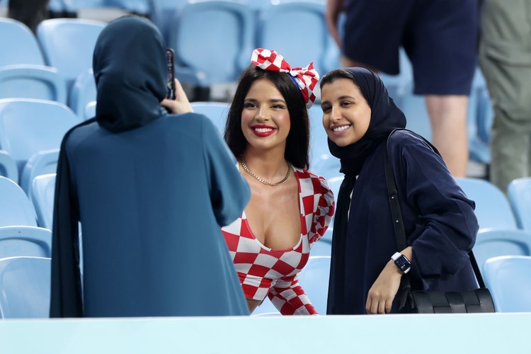 AL WAKRAH, QATAR - DECEMBER 05: Ivana Knoll, former Miss Croatia poses for a photo with the fans prior to the FIFA World Cup Qatar 2022 Round of 16 match between Japan and Croatia at Al Janoub Stadium on December 05, 2022 in Al Wakrah, Qatar. (Photo by Alex Grimm/Getty Images)